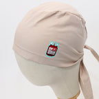 Light pink scrub cap with blood bag vinyl design, side profile showing tie detail