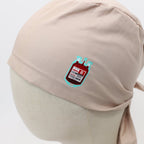 Beige scrub cap with blood bag vinyl transfer patch - close-up detail view