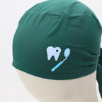 Green scrub cap with dental tooth and mirror vinyl design showing side tie detail