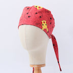 Red Pokemon scrub cap with Pikachu and Pokeball pattern shown on mannequin head side view