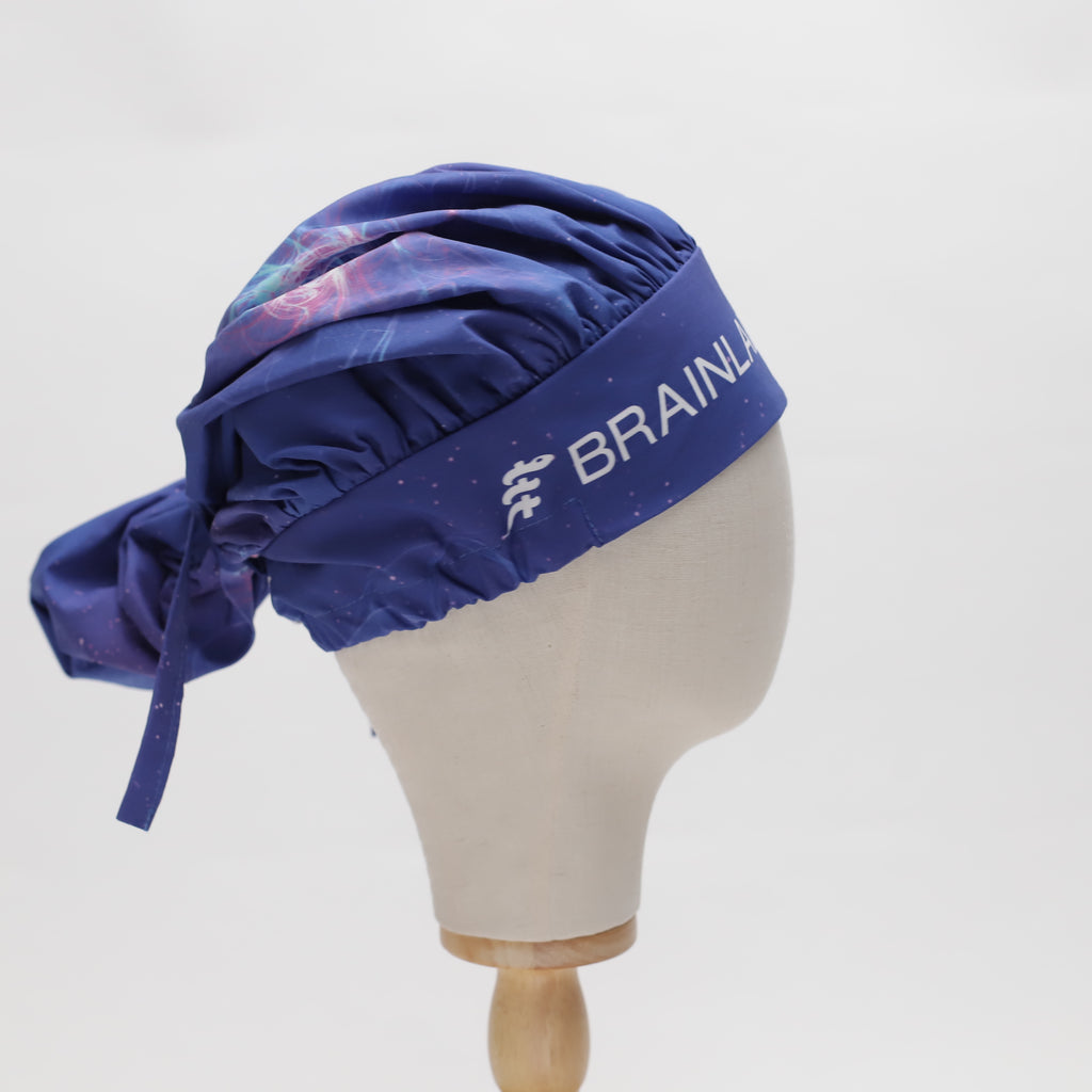 Blue bouffant Medicus Scrub Cap with "BRAINLAB" branding, featuring a galaxy pattern. Reusable and adjustable. @bouffant-scrub-caps-reusable-22-colours.