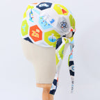Science is Cool scrub cap with colorful hexagonal chemistry symbols pattern, side profile view with tie detail