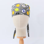 Gray scrub cap with colorful kawaii Star Wars character heads pattern, back view with ties