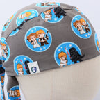 Close-up detail of grey scrub cap showing blue circular patches with cute Star Wars character pairs