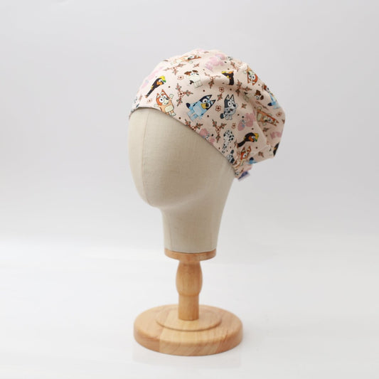 Medicus Scrub Cap featuring a Bluey-themed family and friends pattern on a beige background, displayed on a mannequin head.