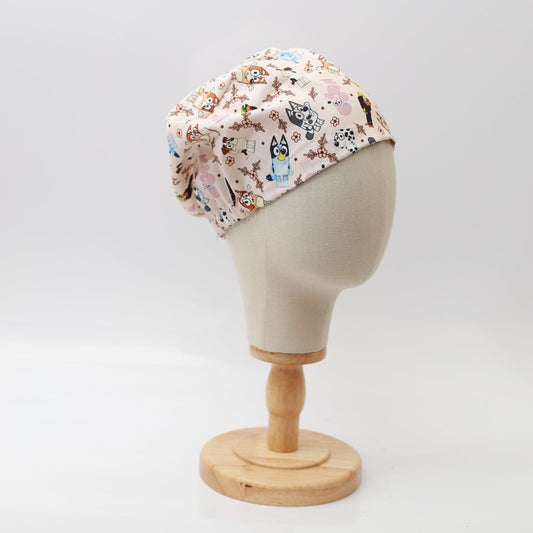 Pink Medicus scrub cap featuring Bluey and friends pattern, displayed on a mannequin head. Fun and stylish headwear for medical professionals.