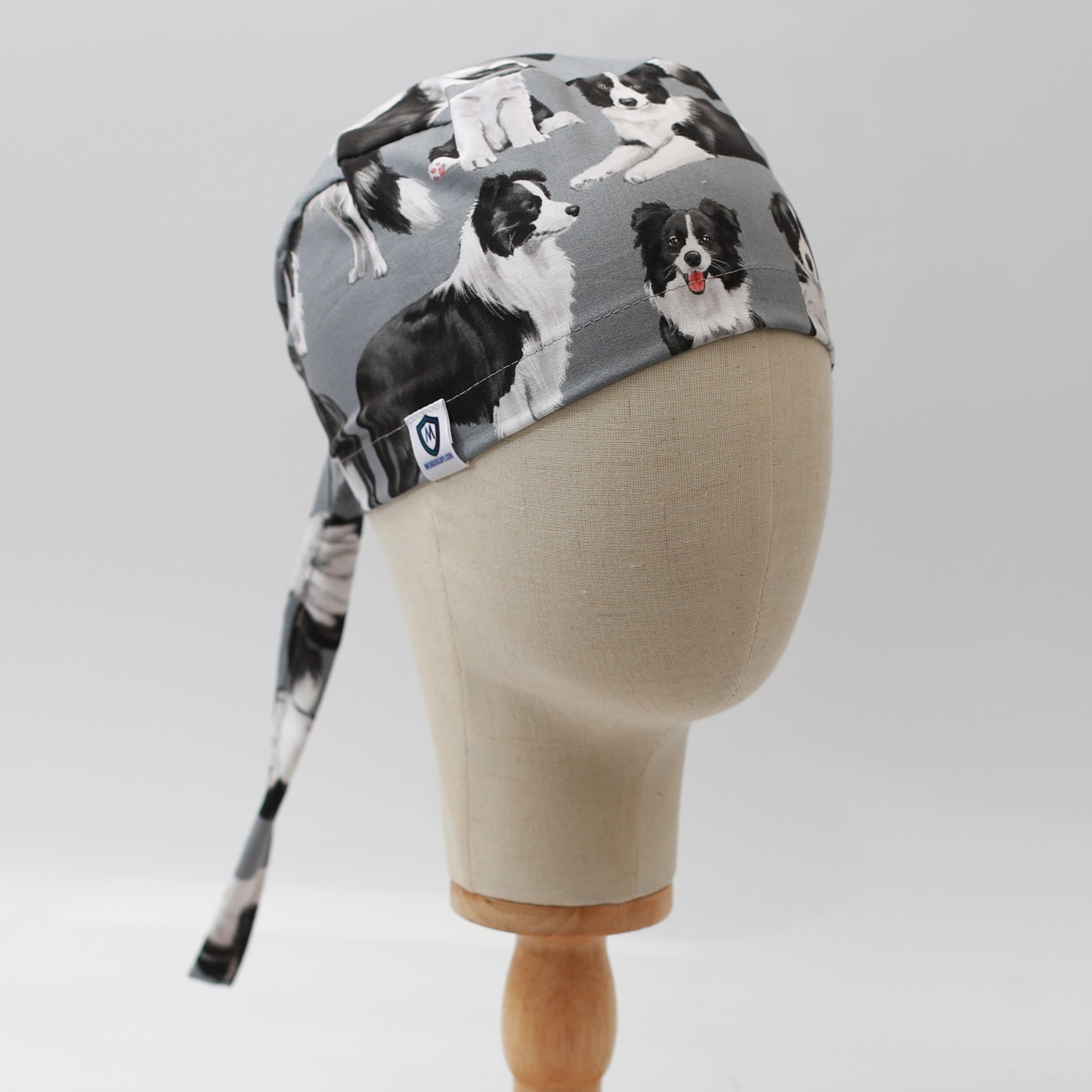 Medicus Scrub Cap featuring a grey background with a Border Collie pattern, displayed on a mannequin head. Stylish and functional for medical professionals.