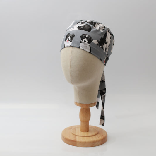 Grey Medicus Scrub Cap featuring a playful Border Collie pattern, displayed on a mannequin head with tie-back detail.