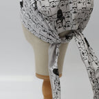 Close-up of white scrub cap tie with black and white Stormtrooper helmet pattern detail