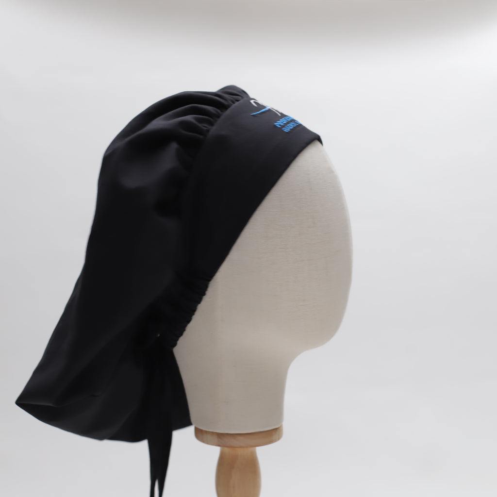 Black bouffant scrub cap by Medicus Scrub Caps, reusable and adjustable. Displayed on a mannequin head. Stylish and functional for medical professionals.