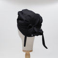 Black bouffant scrub cap by Medicus Scrub Caps, reusable and adjustable with a tie-back design. Stylish and functional for medical professionals.