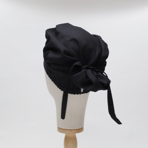 Black bouffant scrub cap by Medicus Scrub Caps, reusable and adjustable with a tie-back design. Stylish and functional for medical professionals.