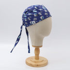 Side view of purple scrub cap with small white robotic surgery medical equipment pattern on mannequin head