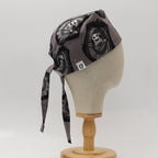 Side view of Nightmare Before Christmas graveyard scrub cap showing skull and reaper pattern on grey fabric