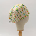 Back view of Cat-cus scrub cap featuring cute green cactus cats pattern on cream background