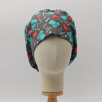 Gray scrub cap with teal and red medical-themed pattern shown on mannequin head front view