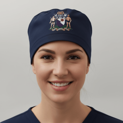 Navy blue scrub cap with embroidered coat of arms crest vinyl transfer design