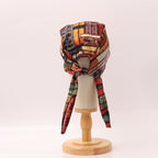 Side view of Old Book Library scrub cap featuring vintage book spine pattern in warm browns and reds