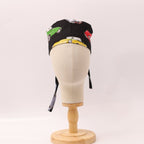 Back view of vintage cars motorsport scrub cap with colorful racing cars on black fabric