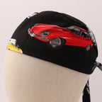 Side view of black scrub cap featuring red vintage sports car design with wire spoke wheels