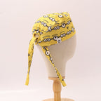 Yellow Minions Eyes scrub cap displayed on mannequin head showing side profile with tie details