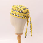Yellow Minions Eyes scrub cap side profile showing tie detail on mannequin head