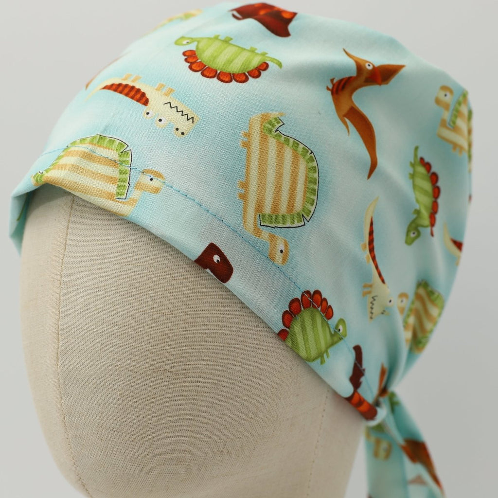 Dinosaurs in a Swamp Light Blue Scrub Cap