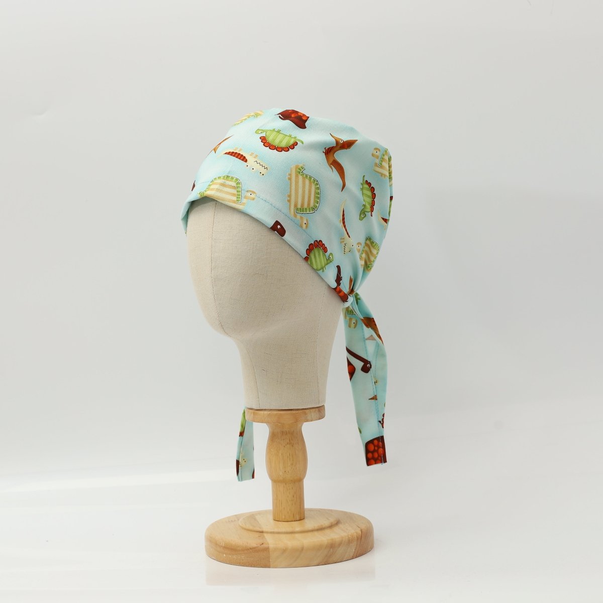 Dinosaurs in a Swamp Light Blue Scrub Cap