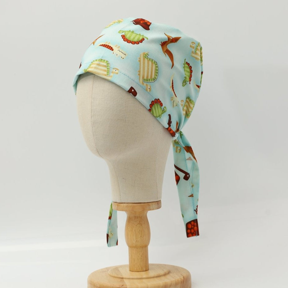 Dinosaurs in a Swamp Light Blue Scrub Cap