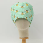 Bees On Teal scrub cap shown on mannequin head