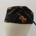 Musical Instruments scrub cap showing black fabric with violin and sheet music pattern, side profile view