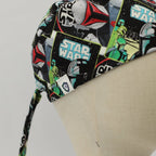 Close-up detail of Star Wars Boba Fett scrub cap showing colorful comic-style pattern with tie strings