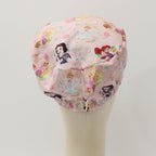 Disney Princesses Mashup Pink scrub cap fabric pattern close-up