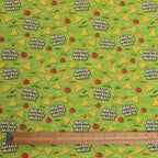 Fabric with 'Nacho Average Nurse' text and graphics on a green background, ruler at the bottom.