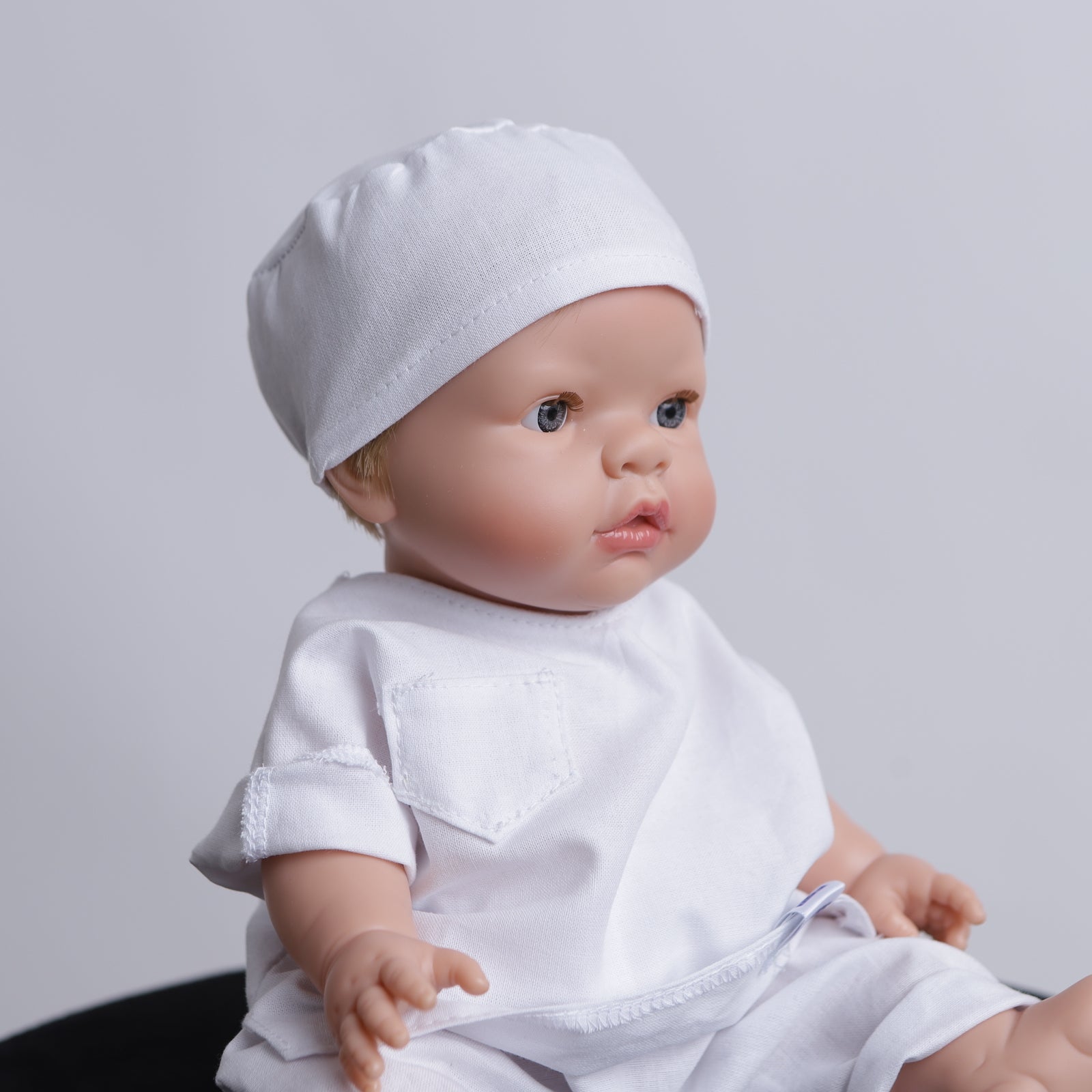 Doll wearing a white Medicus Scrub Cap and matching scrubs. Part of the @doll-scrubs-caps collection with 22 colours available.