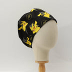 Side view of Pokemon Pikachu yellow on black scrub cap showing character pattern detail