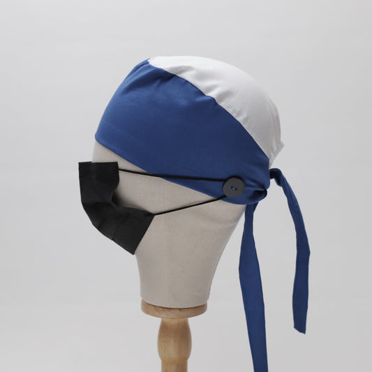 Side view of a mannequin head wearing a two-tone Medicus Scrub Cap with long straps and a black face mask secured with smart buttons.