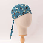 Blue scrub cap with rockets and spaceships pattern shown on mannequin head side view