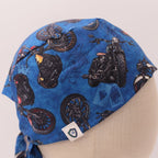 Side view of dark blue scrub cap featuring black motorcycle and wheel pattern designs