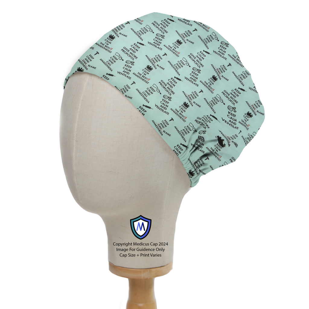Keep Calm And Blame Anaesthesia Scrub Cap from Medicus Scrub Caps, featuring a light green background with black medical-themed text and icons.