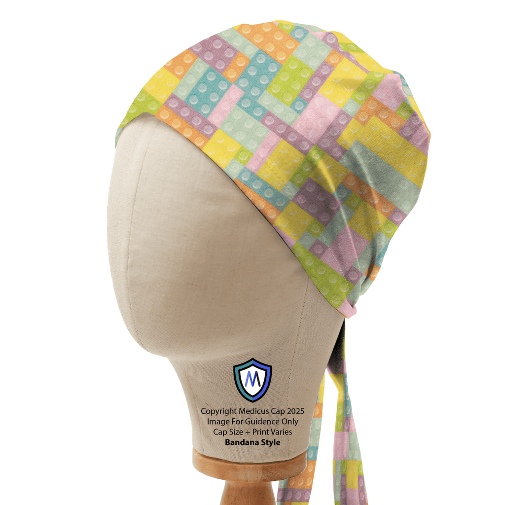 Mannequin head wearing a Medicus Scrub Cap in bandana style, featuring a pastel-colored LEGO brick and Tetris-inspired pattern.