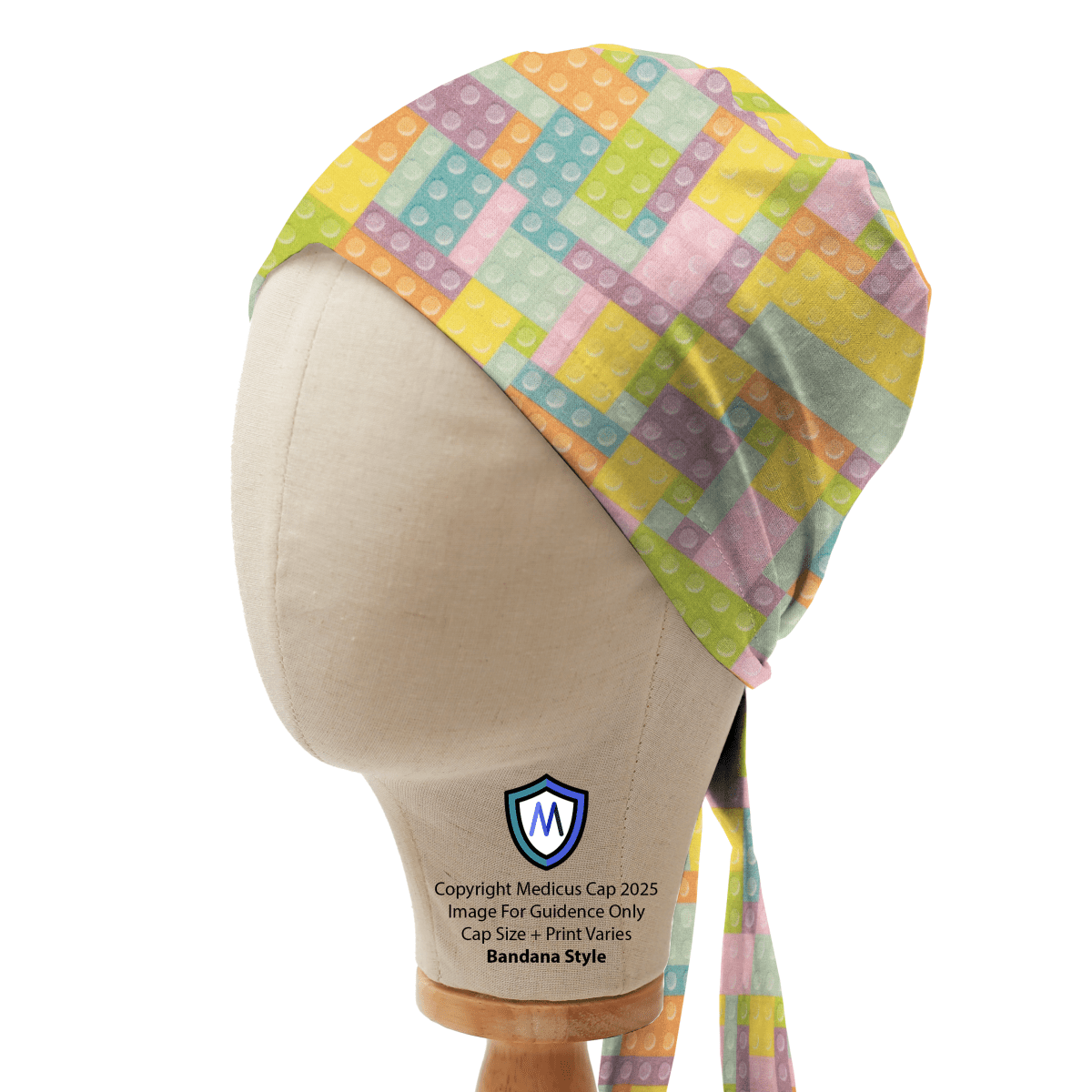 Mannequin head wearing a Medicus Scrub Cap in bandana style, featuring a pastel-colored LEGO brick and Tetris-inspired pattern.