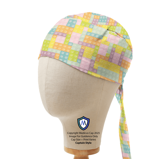 Mannequin head wearing a Medicus Scrub Cap with a pastel-colored LEGO Tetris pattern, long tie, and M logo.