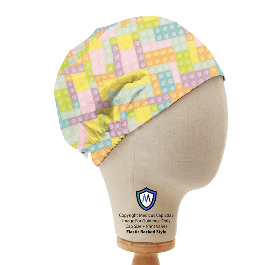 Mannequin head wearing Medicus Scrub Cap with pastel-colored LEGO and Tetris-inspired pattern, featuring an elastic back for a secure fit.