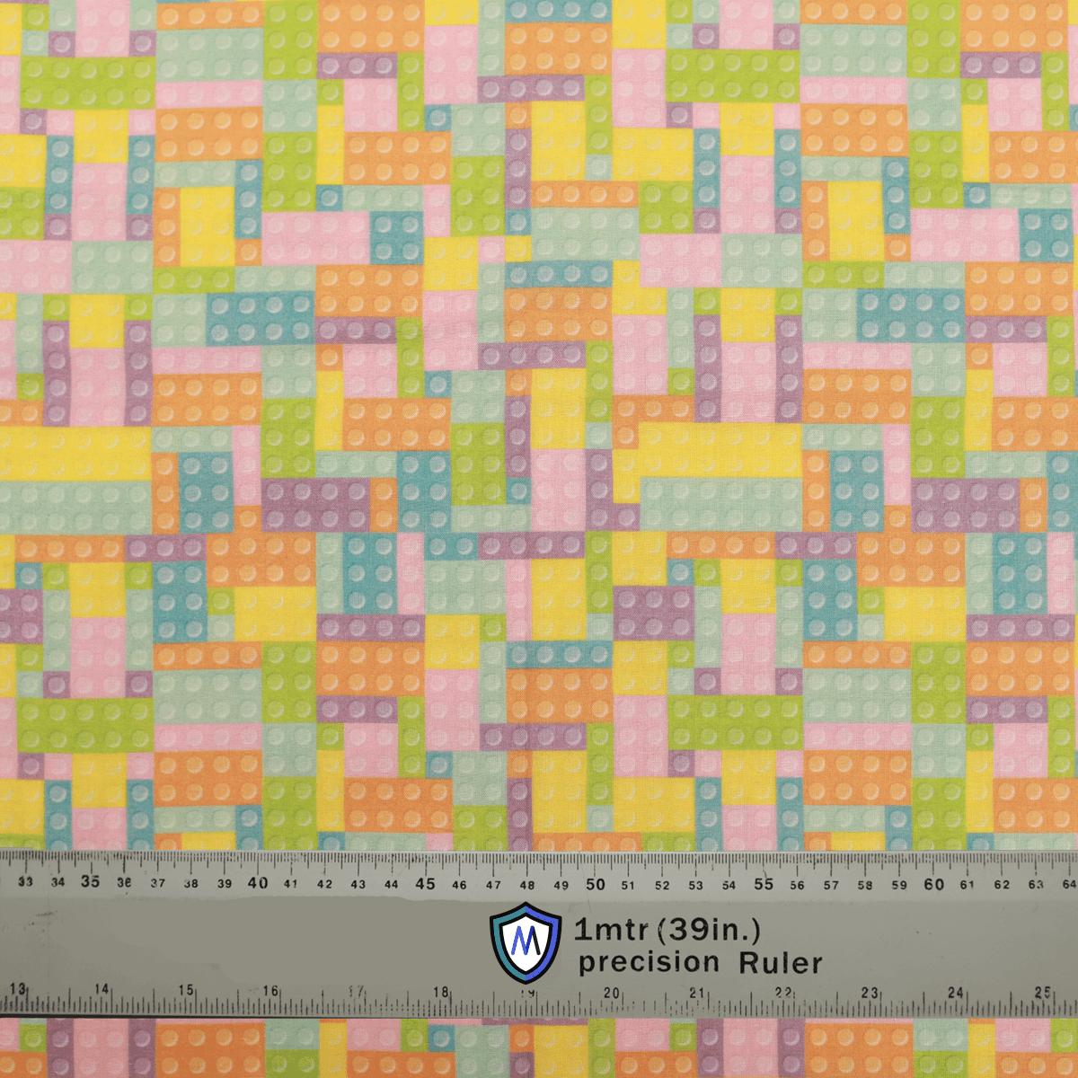 Fabric sample with pastel-colored LEGO and Tetris-inspired pattern, designed for Medicus Scrub Caps. A 1-meter ruler at the bottom provides scale.