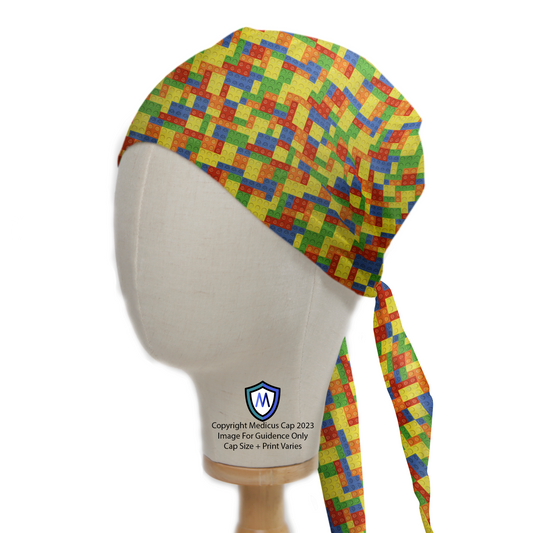 The Medicus Scrub Caps Games Lego Tetris Small Scrub Cap features a colorful Lego Tetris pattern in red, blue, green, and yellow on a mannequin head.