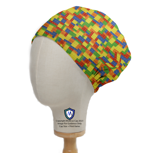 The Medicus Scrub Caps Games Lego Tetris Small Scrub Cap features a colorful interlocking brick pattern, displayed on a mannequin head for a playful, nostalgic look.