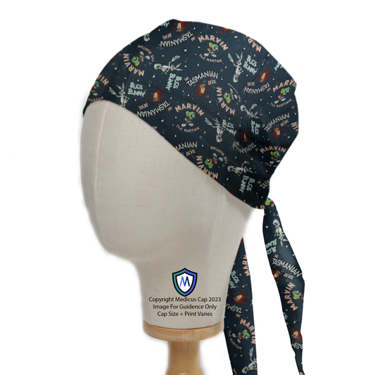 A mannequin head wears a Medicus Scrub Cap with a Looney Tunes space-themed print, featuring Marvin, Bugs Bunny, and Taz. Snug fit with back ties.