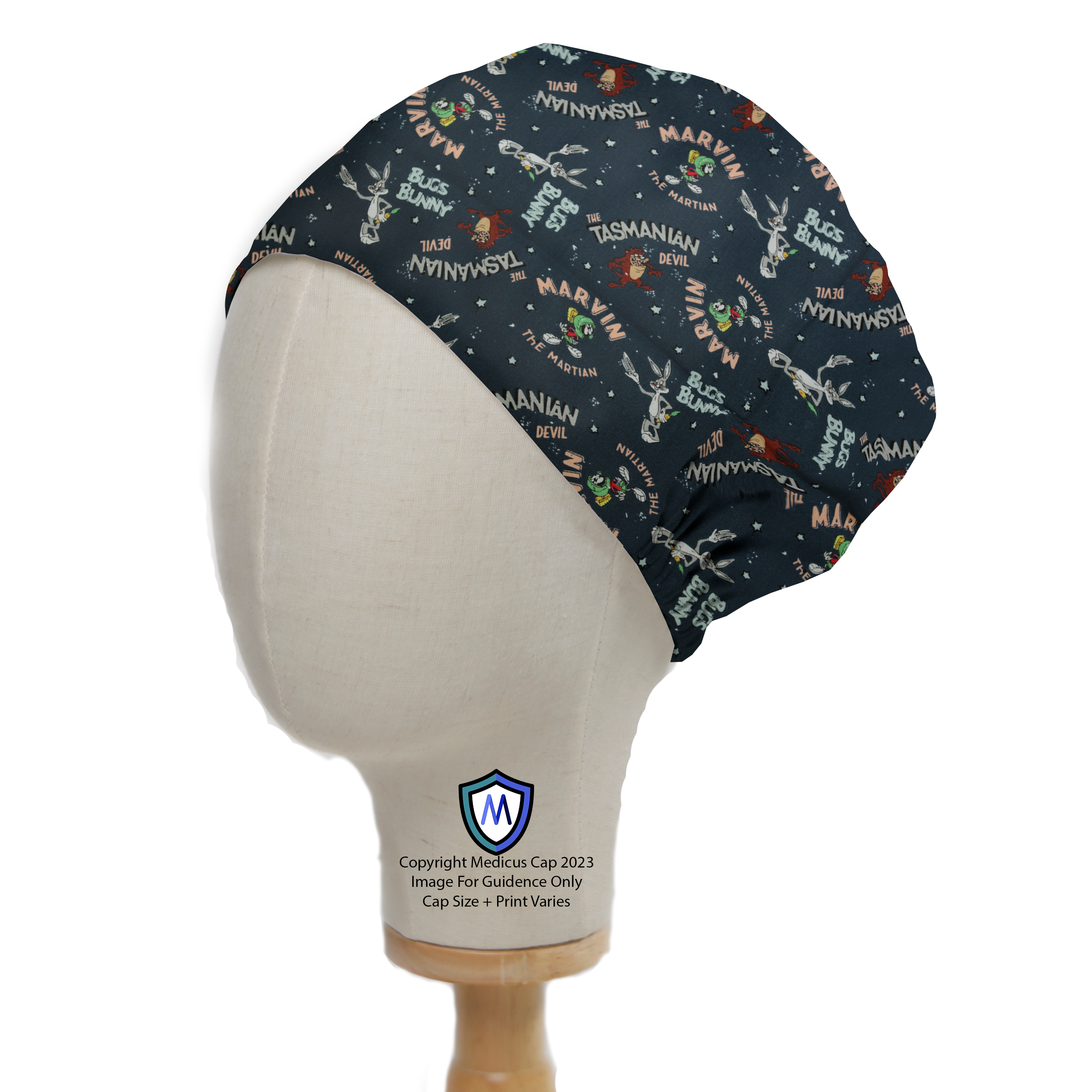 A mannequin head wears the Medicus Scrub Caps Looney Tunes Scrub Cap, featuring Marvin, Taz, and Bugs on a dark blue space-themed background for a fun surgical look.