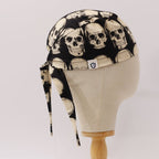 Side view of skulls on dark grey scrub cap showing tie detail on mannequin head